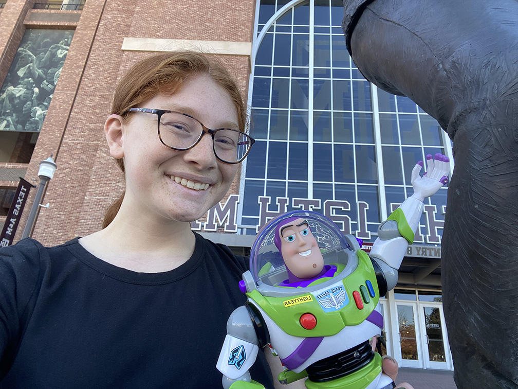 Olivia Hearne holding Buzz Lightyear figure.