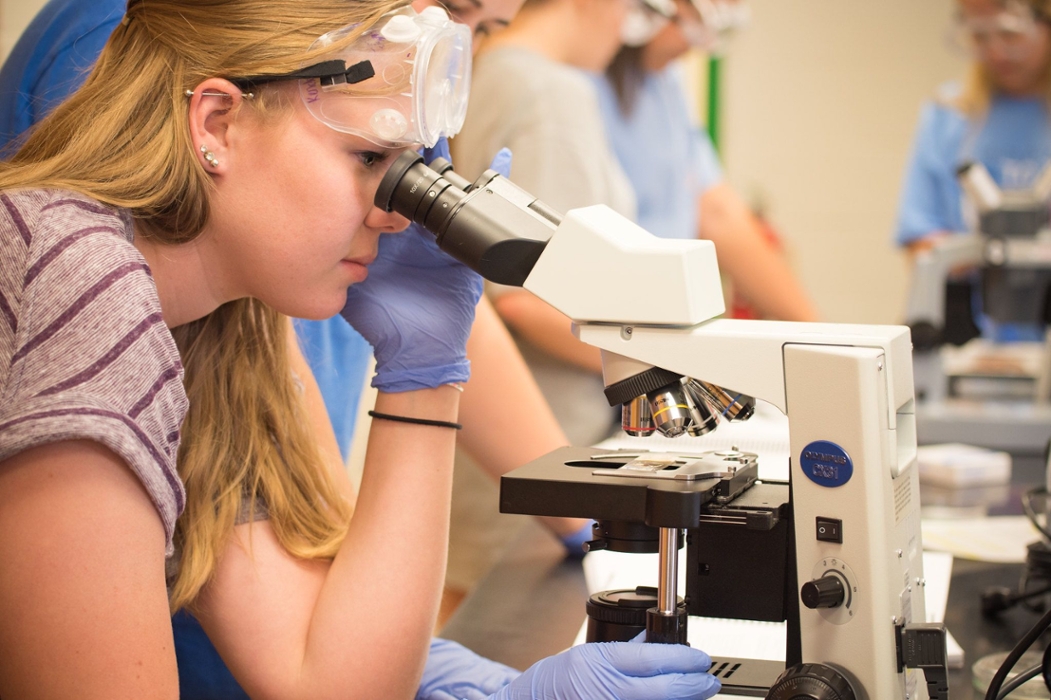 Biology student using a microscope.