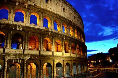 Colosseum in Rome, Italy against night sky.