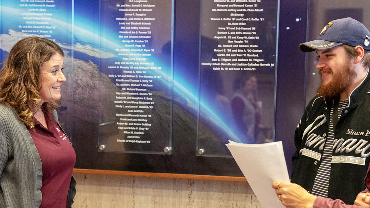 Two individuals talking in the Geosciences building