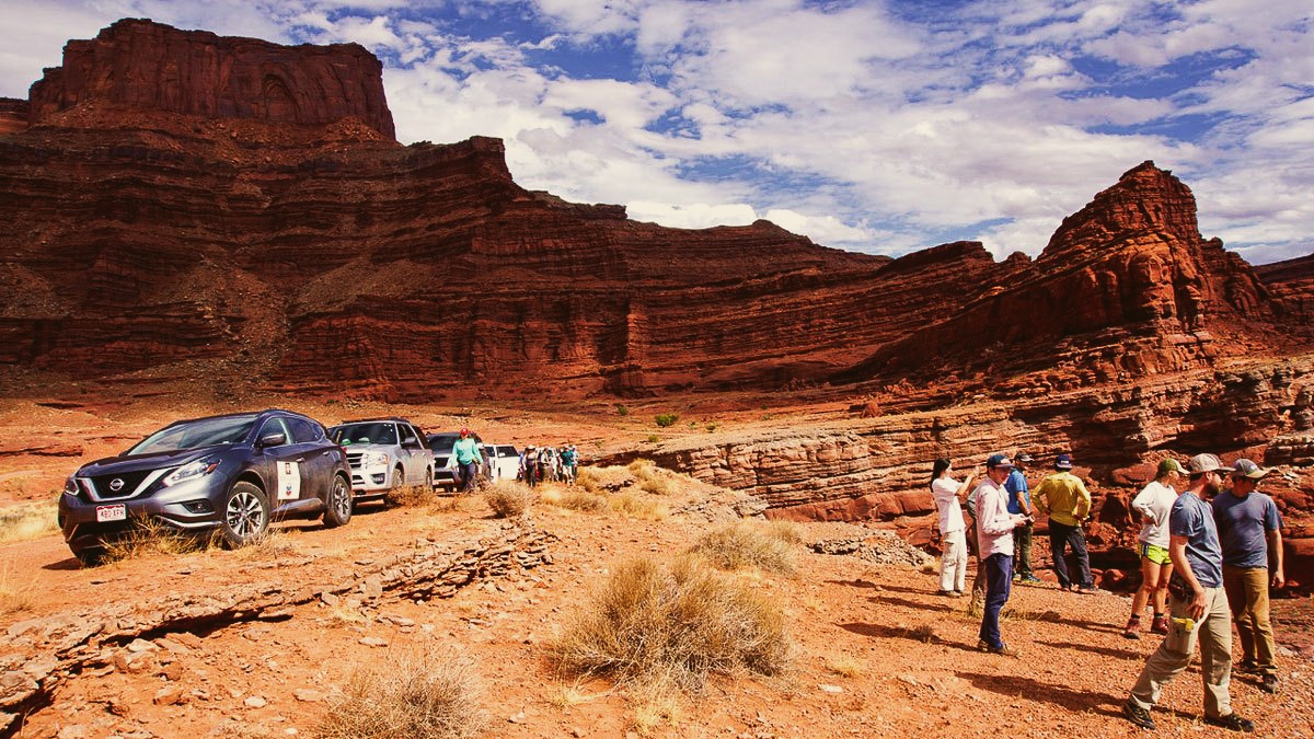 Large group of students in the desert near rock formations