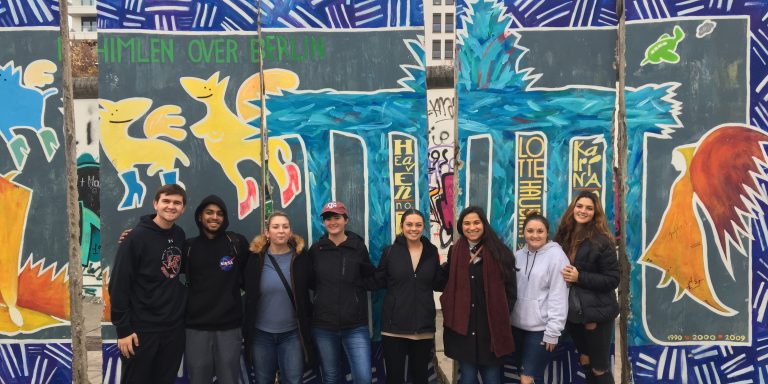 Students in front of the Berlin Wall