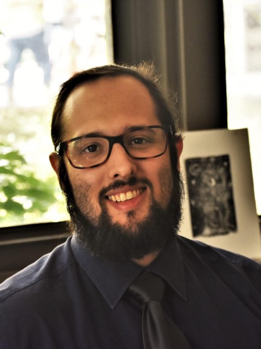 Headshot of Ian Seavey in an office setting