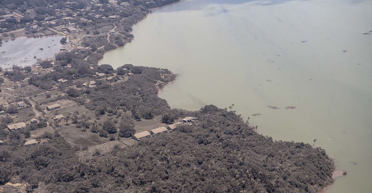 In this handout photo provided by the New Zealand Defense Force, an aerial view from a P-3K2 Orion surveillance flight of homes covered in ash on Jan. 17, 2022 Nomuka, Tonga. Tonga was struck by a tsunami caused by an undersea volcano erupting in the Pacific Ocean on Jan. 15. (New Zealand Defense Force via Getty Images.)