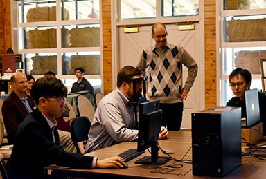 Dr Anderson teaching in a classroom of students