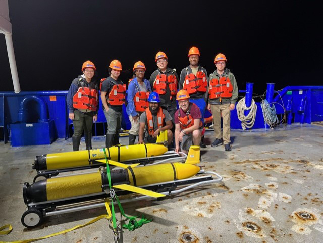 A group of researchers including Texas A&amp;M professor and chief scientist Steven DiMarco on the deck of the R/V Pelican with two Teledyne-Webb Slocum buoyancy gliders