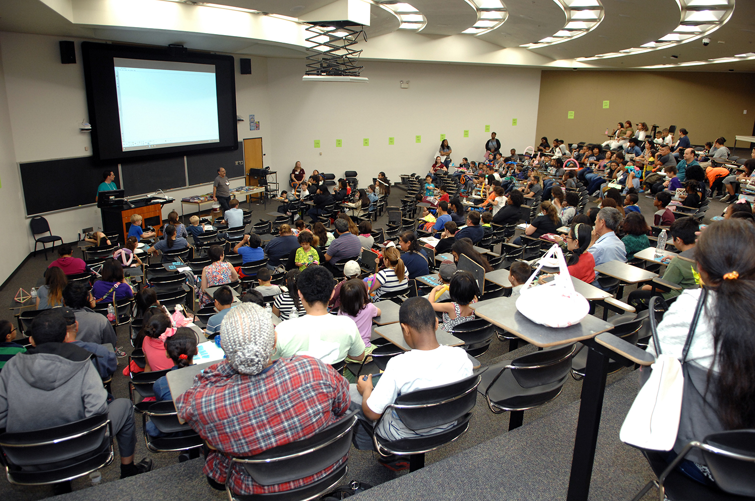 Math faculty present to a packed lecture hall at the Math and Stat Fair