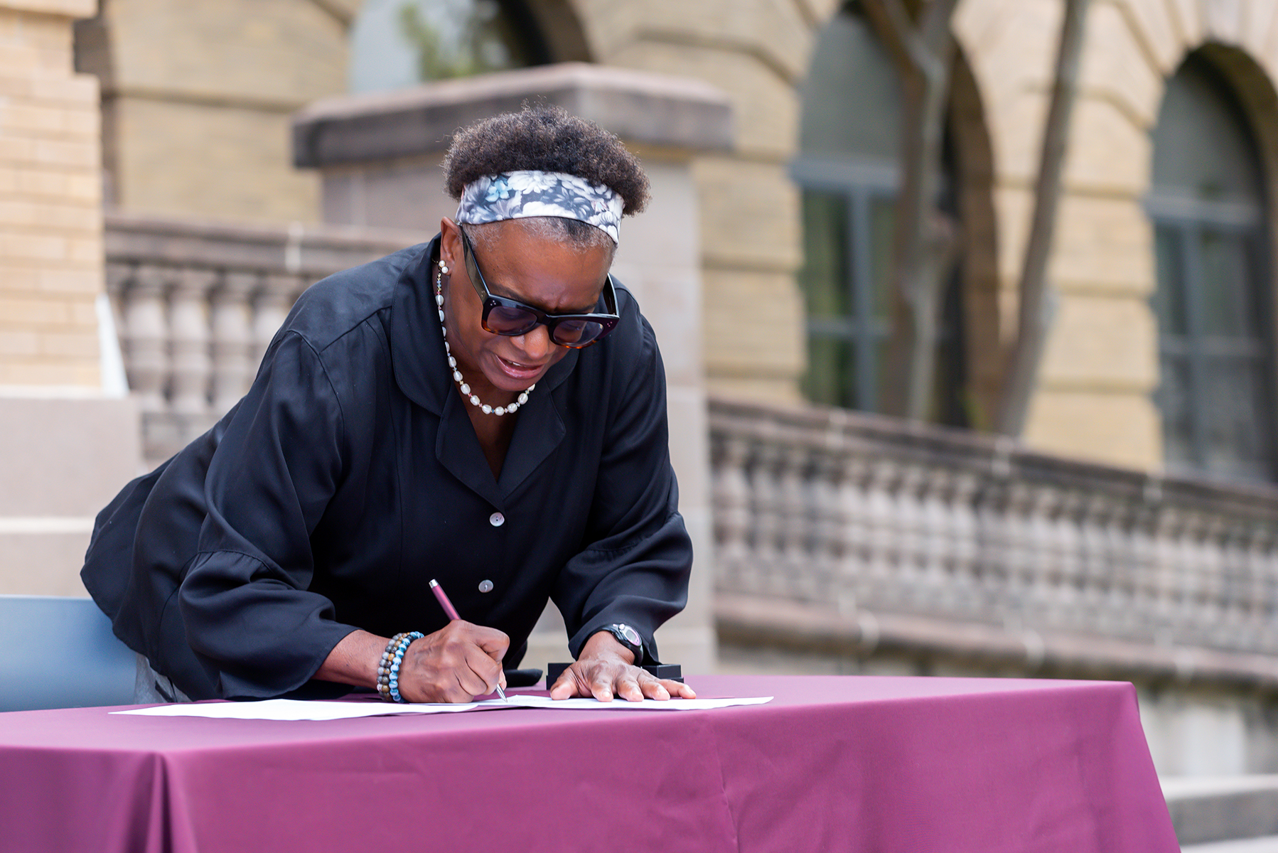 Dr. Kathleen McElroy signs her appointment letter naming her director of the Texas A&amp;M Journalism Program