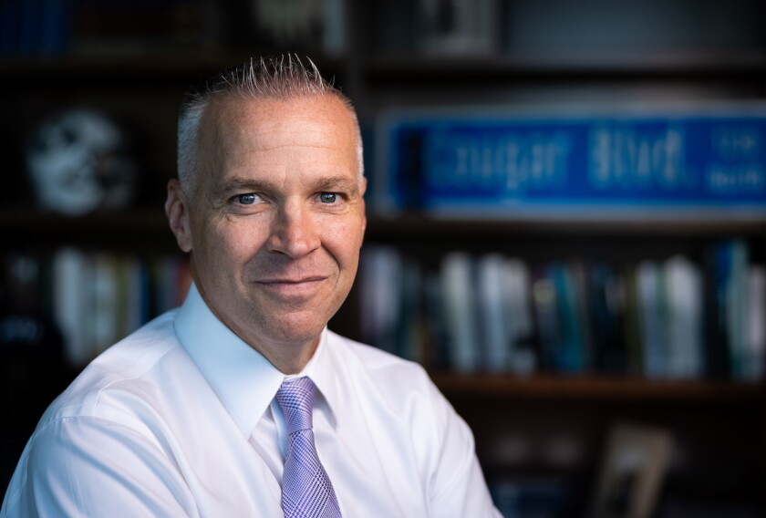 Brigham Young University President and Statistician C. Shane Reese, posing in his campus office