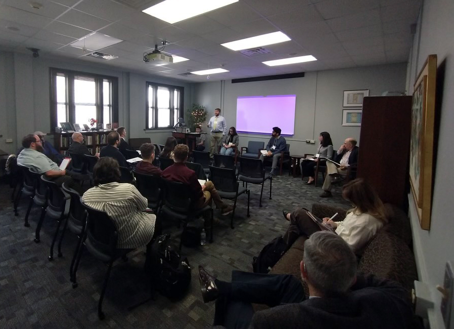 A speaker presents to a small group of 2023 History Graduate Student Organization 13th Annual Conference attendees within the Glasscock Building at Texas A&M University