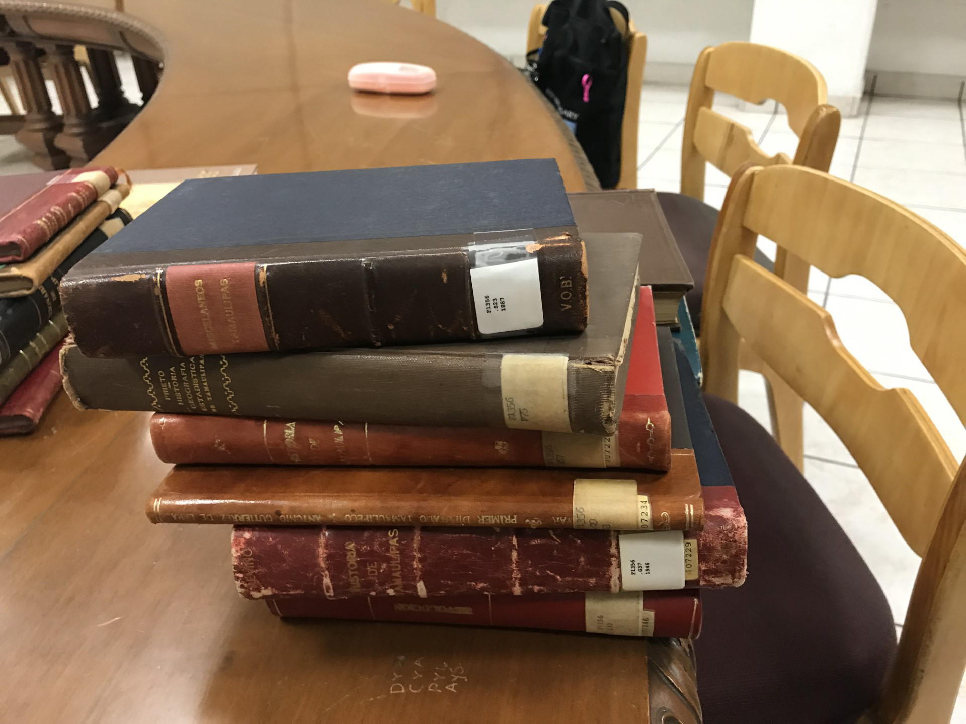 A stack of books sitting on a table within the Universidad Autónoma de Nuevo León in Monterey, Mexico