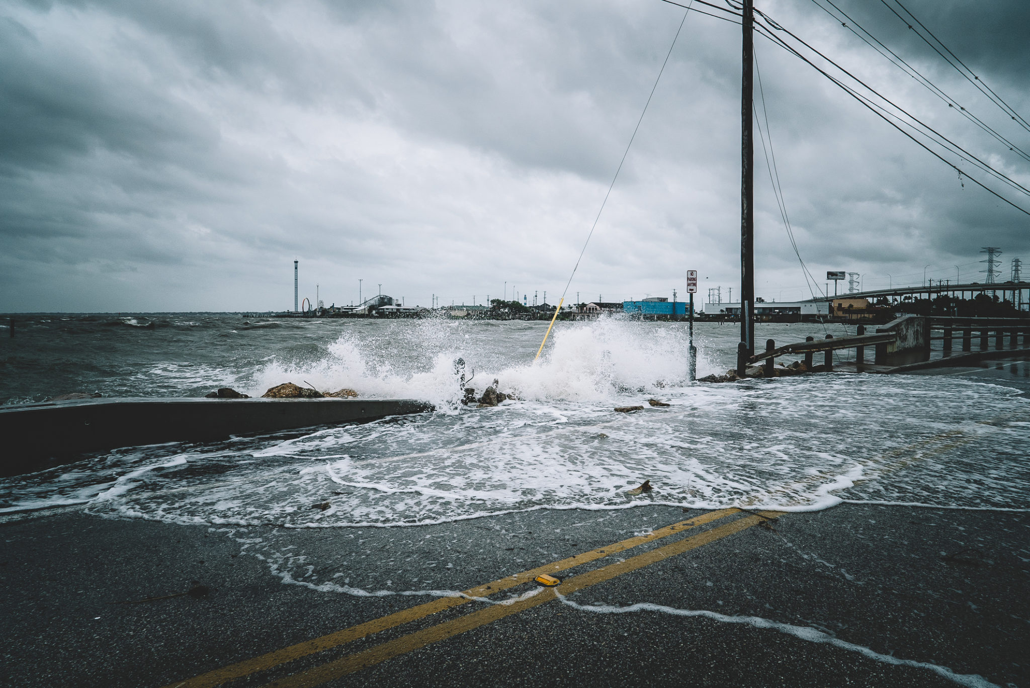 Water crashes over a road during Hurricane Harvey in Kemah, Texas