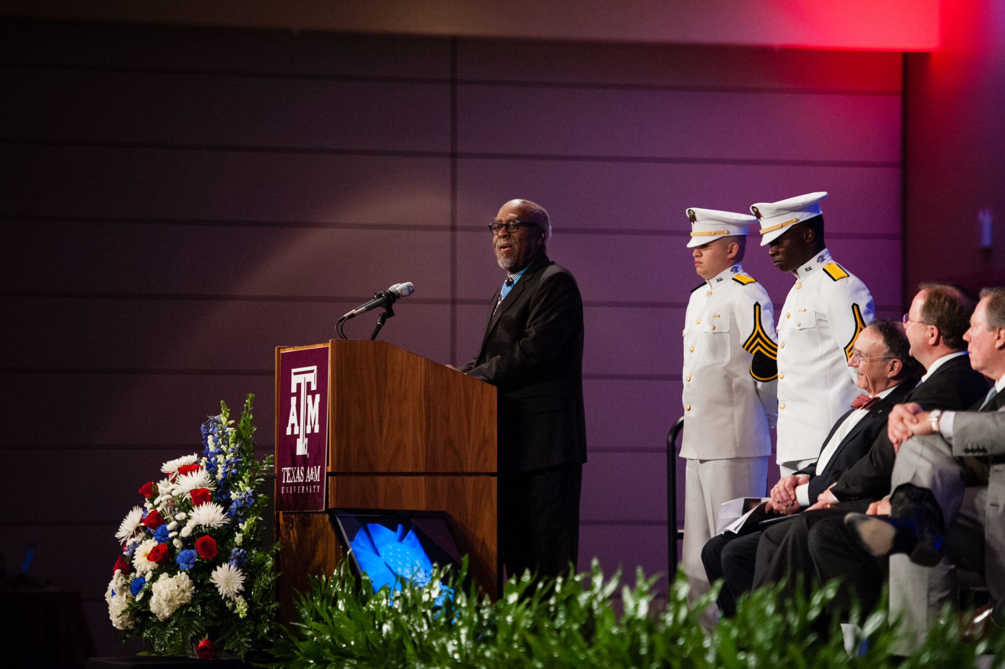 Texas A&amp;M University chemistry former student and Congressional Medal of Honor recipient Clarence Sasser speaks at a podium during his Hall of Honor recognition ceremony, held November 7, 2013, in the Memorial Student Center