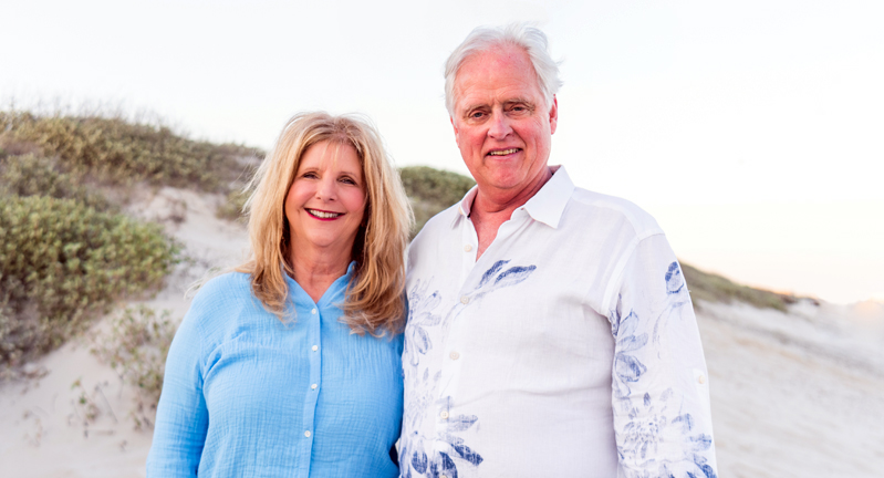 Texas A&M University former students and College of Arts and Sciences donors Clarissa and Steve Streetman smile for the camera while on a beach