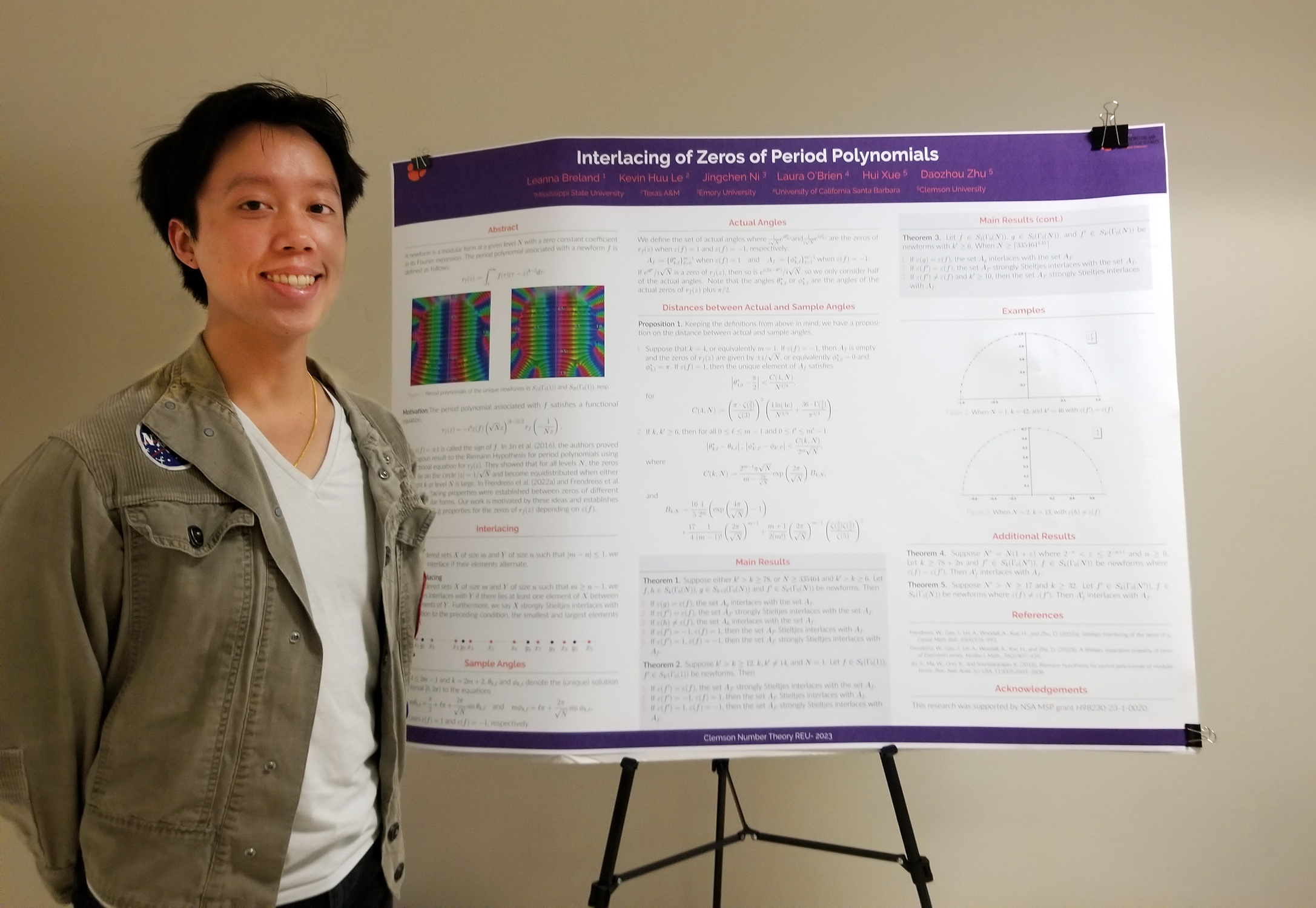 Texas A&amp;M University mathematics major Kevin Le poses beside a poster describing his research on period polynomials