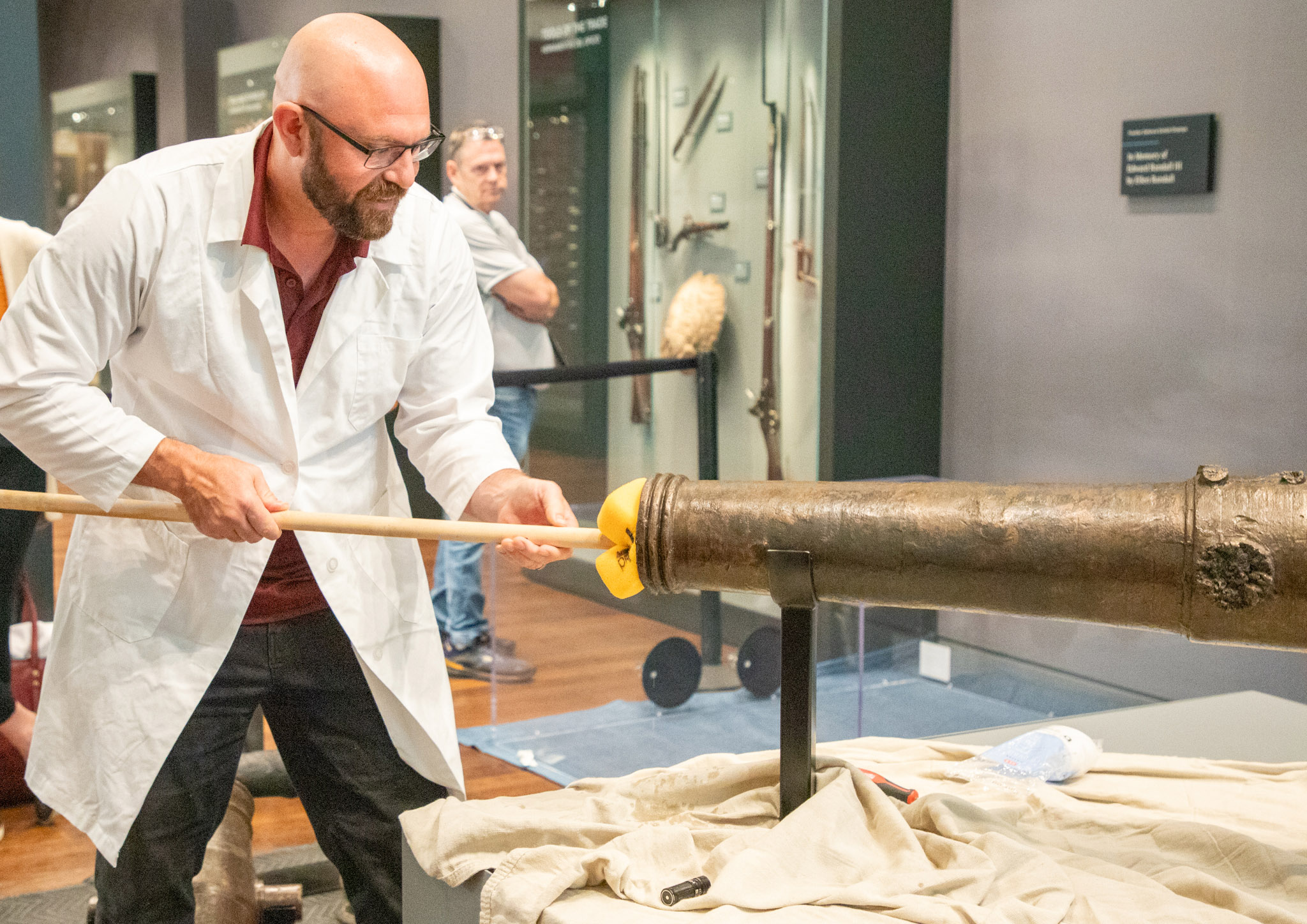 Texas A&amp;M University anthropologist and nautical archaeologist Chris Dostal swabs the bore of a four-pound bronze cannon used in the Battle of the Alamo