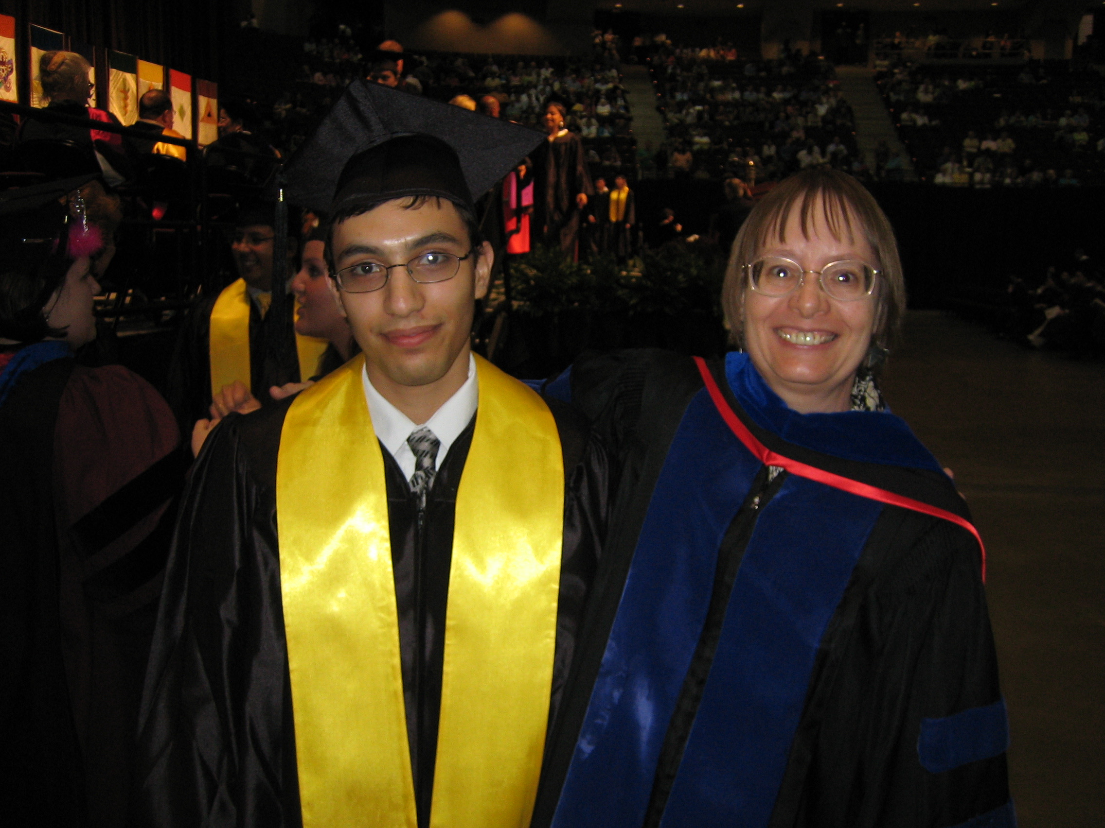 Carlos Cantu (left) with Debby Siegele, both in graduation garb, at his 2005 graduation