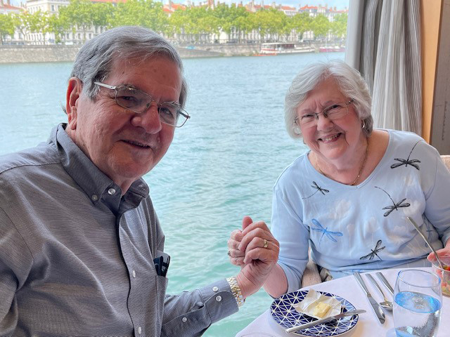 Texas A&amp;M University former student and statistician Dr. William B. Smith and Patricia Smith hold hands while dining near a waterfront