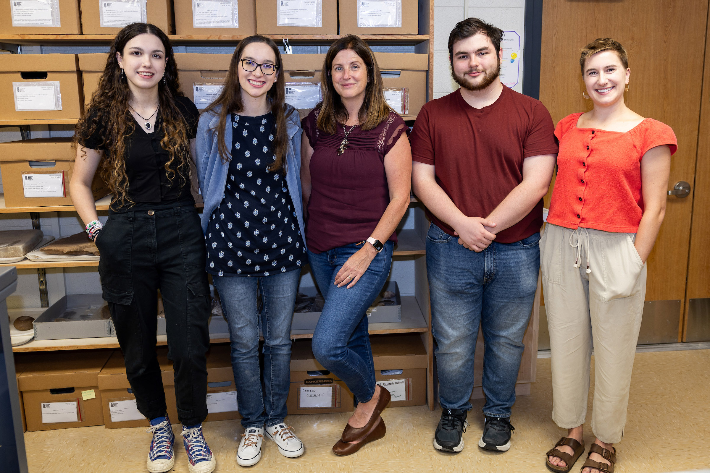 Group photograph of Texas A&amp;M University Anthropology Research Collections staff (from left) Lily Dempsey, Bradie Dean, Dr. Katie Custer Bojakowski, Jason Brickley and Emma Newman, taken within the ARC on October 1, 2024