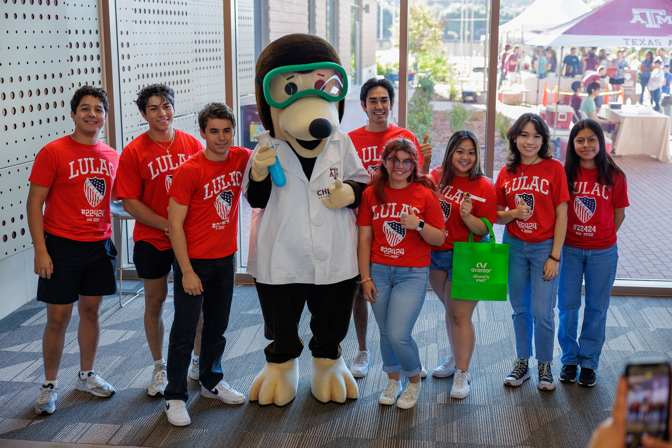 The Texas A&amp;M Chemistry mole poses with a group of school kids at the 2023 Chemistry Open House