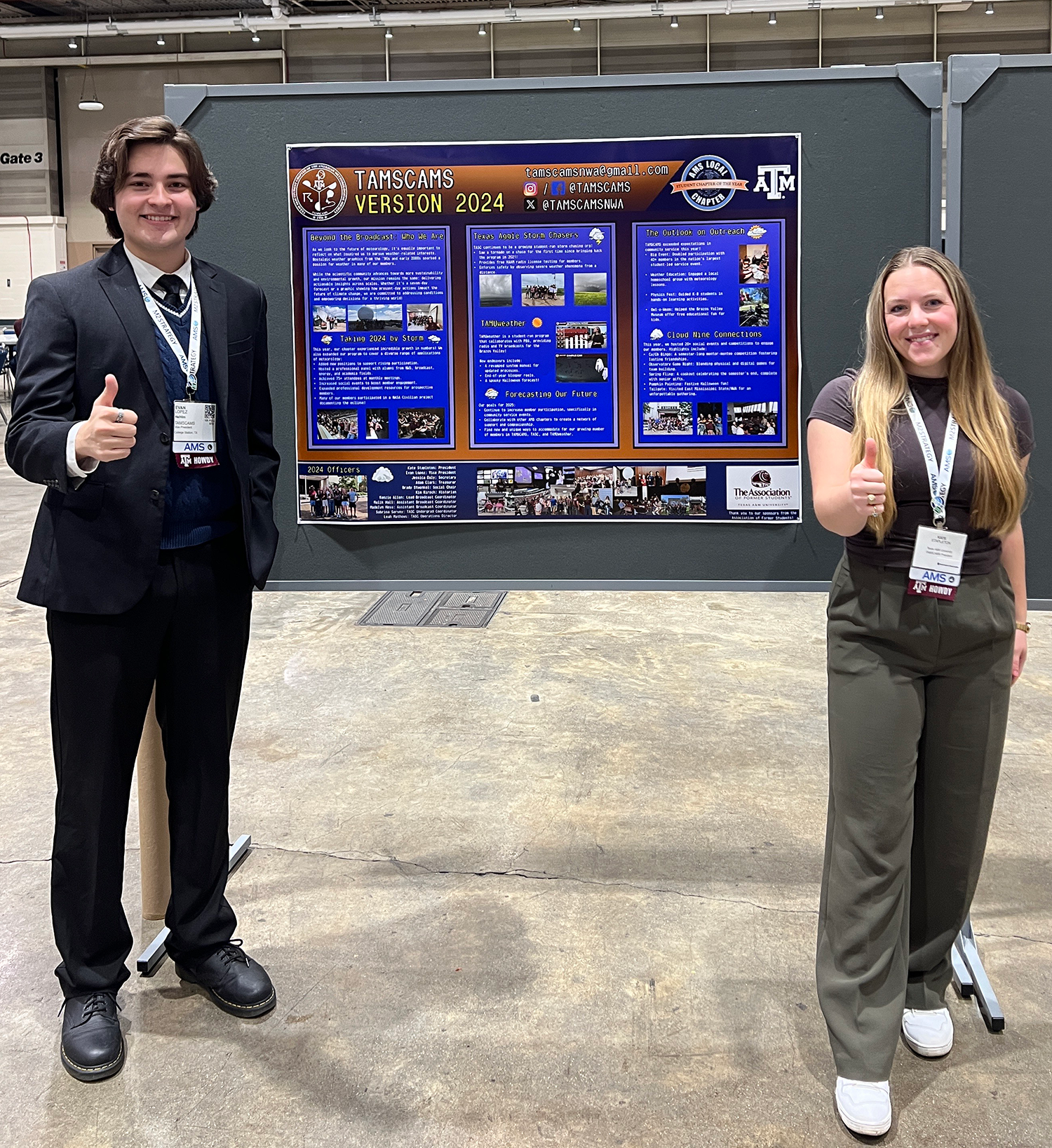 Evan Lopez and Kate Stapleton are standing beside a TAMSCAMS Version 2024 presentation poster at a conference. Both are giving a thumbs up.