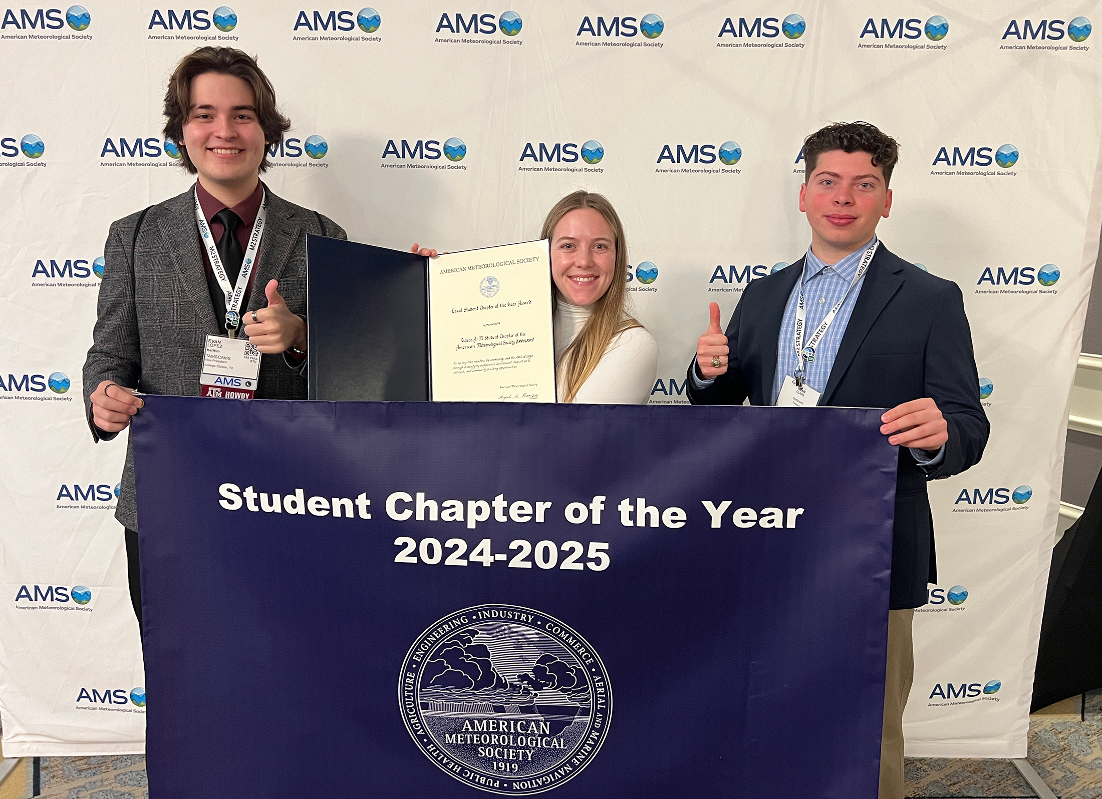 From left to right: TAMSCAMS' Vice President Evan Lopez ’26, President Kate Stapleton ’25, and Treasurer Adam Clark ’26 proudly accept the banner and award for the AMS Student Chapter of the Year.