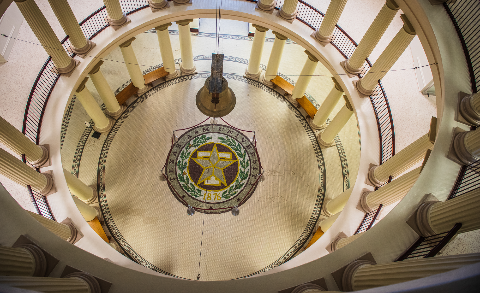 Overhead view of a rotunda floor with Texas A&amp;M University seal, surrounded by columns.