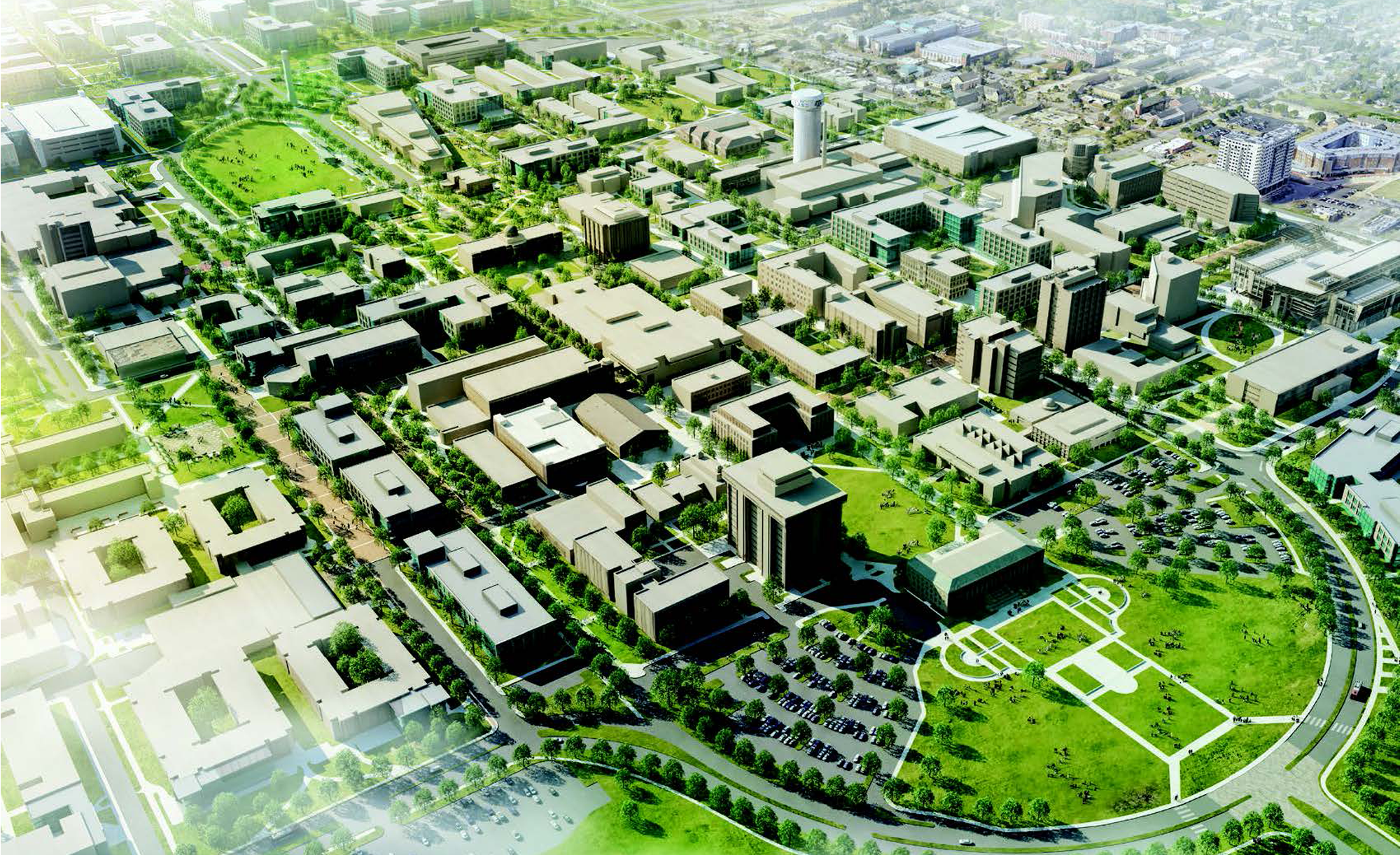 Aerial view of a university campus featuring a mix of modern and traditional buildings, green spaces, tree-lined pathways, sports fields, and parking lots, showcasing the expansive and organized layout of the area
