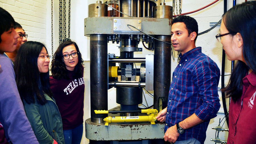 photo of students with heavy machinery