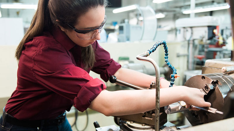 Student in lab working on machine